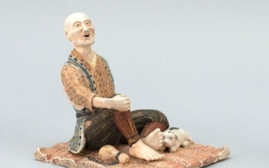 SATSUMA POTTERY FIGURE GROUP Depicting a man with a sake bottle and his dog. Length 6".