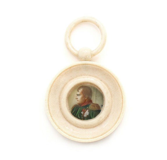 A 19th century miniature portrait of Napoleon Bonaparte, mounted in a circular ivory frame with ring handle. Frame diam. 5 cm.