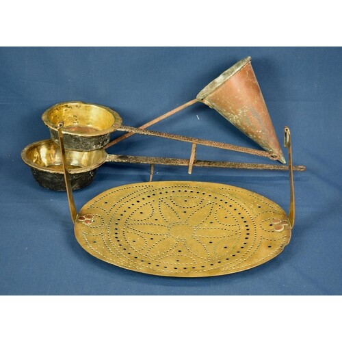 A 19th century or earlier pierced brass hanging trivet stand...