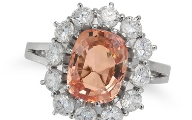 A 3.85 CARAT CEYLON NO HEAT PADPARADSCHA SAPPHIRE AND DIAMOND CLUSTER RING set with a cushion cut...