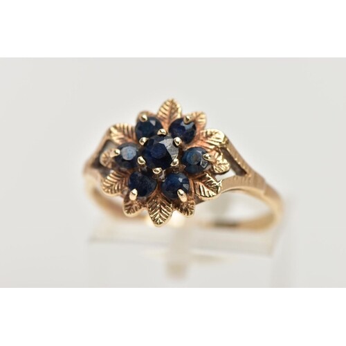 A 9CT GOLD SAPPHIRE CLUSTER DRESS RING, of a flower shape, s...