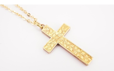 A 9ct gold rolo chain, hung with a 15ct gold cross. Chain we...