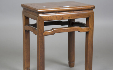 A Chinese hardwood stand, late Qing dynasty, the rectangular panelled top above a waisted apron and