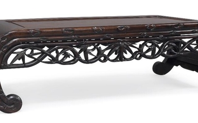 A Chinese hongmu opium table, late Qing dynasty, with recessed top and bracket shaped legs, the frieze carved with bamboo sprays, 122cm x 56xm x 35cm. 清晚期 紅木雕几