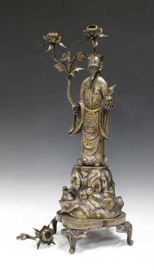 A Chinese mixed metal inlaid bronze sectional figure of an immortal on stand, late Qing dynasty, the