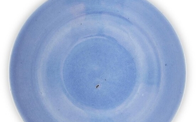 A Chinese monochrome blue-glazed dish, early 19th century, covered allover in a pale blue glaze, 29cm diameter 十九世紀早期 天藍釉碟
