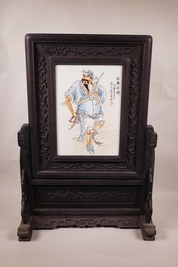 A Chinese polychrome porcelain and hardwood framed table scr...