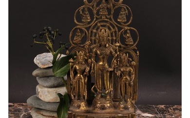 A Chinese/Tibetan gilt bronze shrine figure, cast with three...