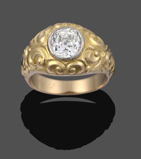 A Diamond Solitaire Ring, the old cut diamond in a yellow millegrain setting to a floral chased...