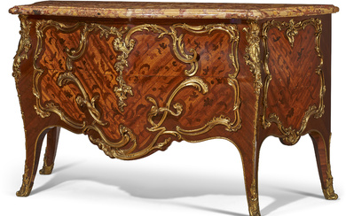 A FRENCH ORMOLU-MOUNTED BOIS SATINE, MAHAOGANY AND BOIS-DE-BOUT MARQUETRY COMMODE...