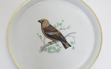 A French L Lourioux Le Faune plate with a gilt rim