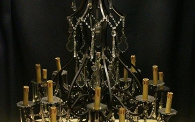 A GOOD LARGE PATINATED BRASS AND CUT GLASS CHANDELIER