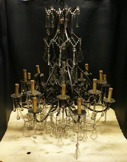 A GOOD LARGE PATINATED BRASS AND CUT GLASS CHANDELIER