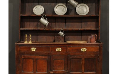 A George III oak and fruitwood dresser, outswept cornice abo...