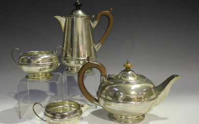 A George V silver four-piece tea set of circular girdled form, comprising teapot, hot water jug, two