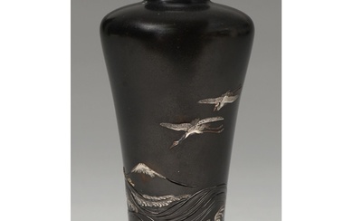 A Japanese bronze vase, Meiji period, carved and inlaid in g...