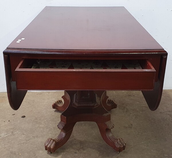 A MAHOGANY DROPSIDE TABLE ON A CLAW FOOT PEDESTAL