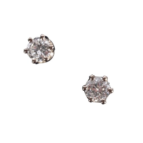 A PAIR OF DIAMOND EAR STUDS claw-set in unmarked white metal