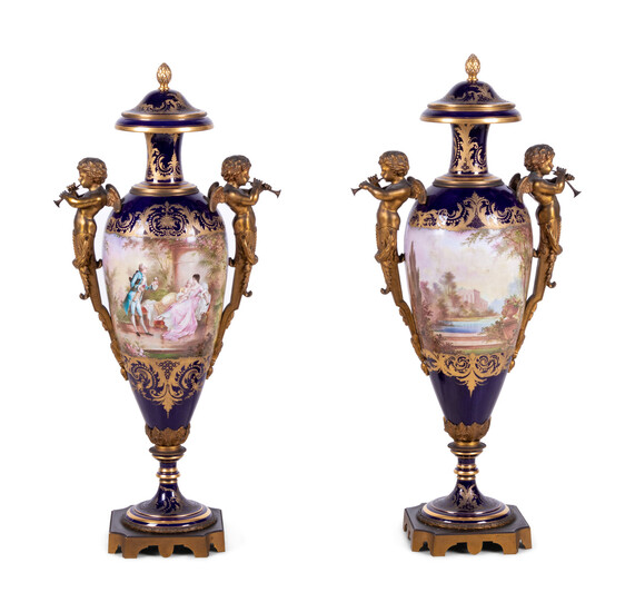 A Pair of Sèvres Style Gilt Bronze Mounted Painted and Parcel Gilt Porcelain Urns