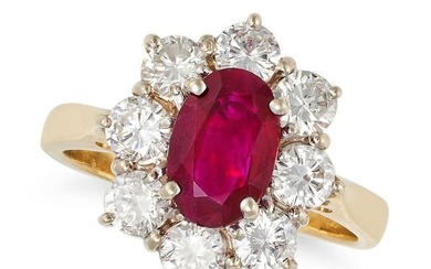 A RUBY AND DIAMOND CLUSTER RING in 18ct yellow gold, set with an oval cut ruby of approximately 1.04