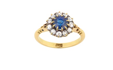 A Sapphire and Diamond Cluster Ring the round cut sapphire...