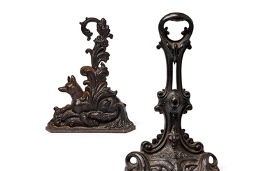 A Victorian cast iron door stop in Rococo Revival taste