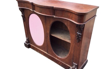 A Victorian mahogany side cabinet, the serpentine top and conforming...