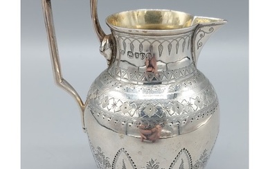 A Victorian silver cream jug, with engraved decoration and s...