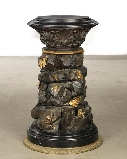 A carved wood pedestal with frog and beetle