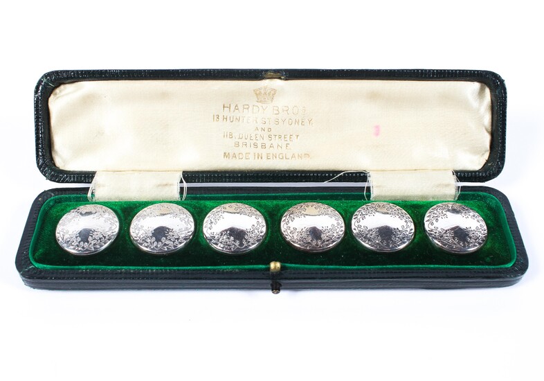 A cased set of six circular gentleman's sterling silver buttons with chased decoration