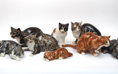 A collection of Mike Hinton pottery cats, to include two ginger cats, largest 17cm high, two Calico cats and the rest Tabby cats, all featuring glass eyes and hand-painted glaze, all bearing hand-painted signatures, tallest 23cm high (8)