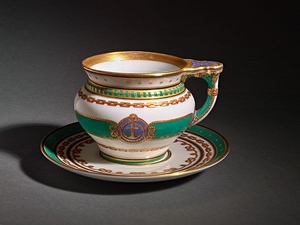 A cup and saucer from the ceremonial service of the imperial yacht « Derzhava ». Based on the project of I.A. Moneghetti (1819-1878) Porcelain, polychrome overglaze painting, gilding Stamps: in green AII, in red ID 7,2 x 11,2 x 8,9 cm (cup); 2,5 x...