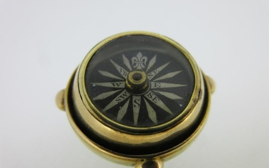 A gimbal compass pendant