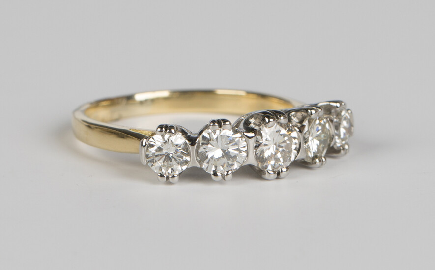 A gold and diamond five stone ring, claw set with circular cut diamonds graduating to the centre, un