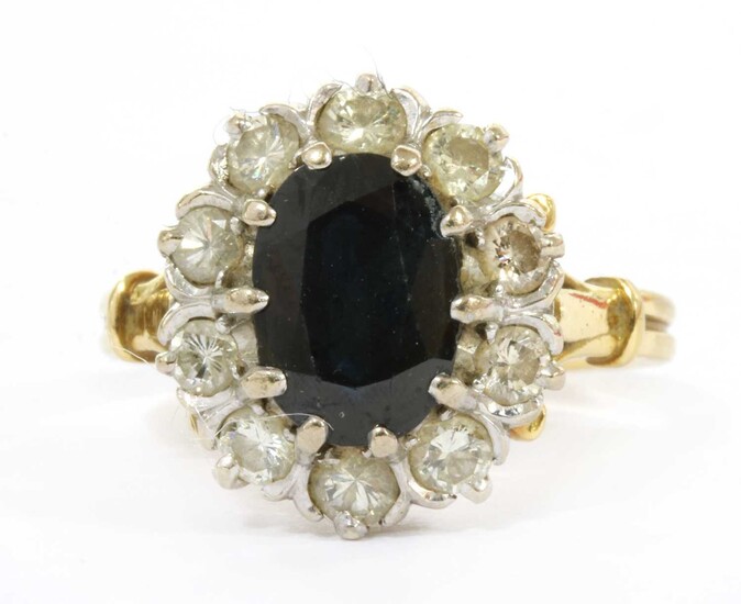 A gold sapphire and diamond cluster ring