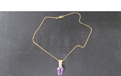 A hallmarked 9ct yellow gold pear shaped amethyst pendant on...