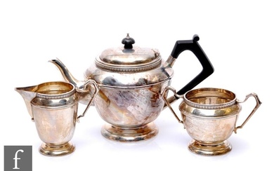 A hallmarked silver three piece pedestal tea set each with a...