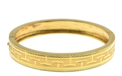 A hinged bangle.Oriental marks to indicate high carat