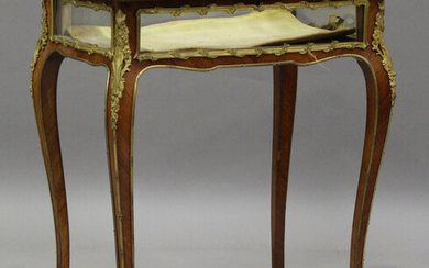 A late 19th/early 20th century French kingwood bijouterie table with gilt metal mounts, the hinged l