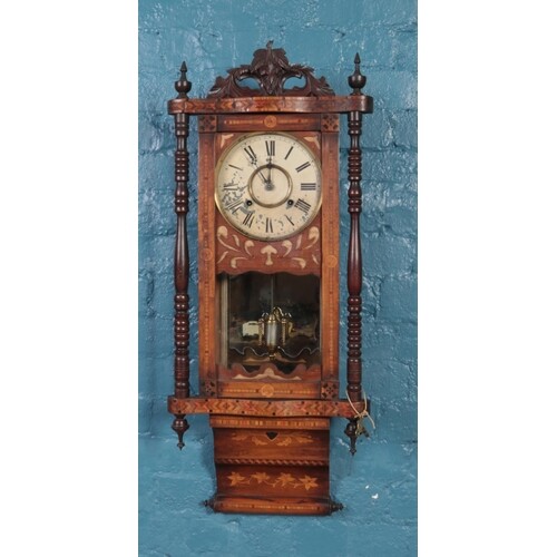 A mahogany Vienna 8 day wall clock with inlay detailing. (wi...