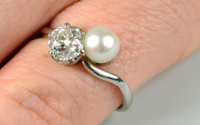 A mid 20th century platinum, old-cut diamond and cultured pearl crossover ring.