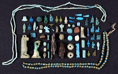 A miscellaneous group of Egyptian faience amulets, pendants and beads, New Kingdom – Late Period, circa 1400 – 332 B.C. including New Kingdom jewellery elements of petals, flowers, recumbent sphinx, falcon, Bes, poppy seed pods, the head of Hathor...