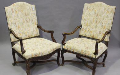 A near pair of 19th century French walnut framed armchairs, upholstered in patterned fabric, raised