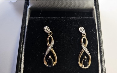 A pair of Diamond and Sapphire Earrings.