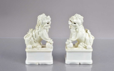 A pair of antique Chinese blanc-de-chine porcelain foo dogs or guardian lions