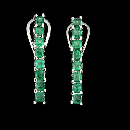 A pair of emerald ear pendants each set with numerous emerald-cut emeralds, mounted in rhodium plated sterling silver. L. 2.3 cm. (2)