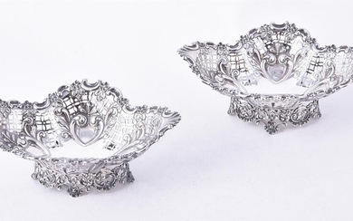 A pair of late Victorian silver shaped oval pedestal sweet baskets by James Dixon & Sons