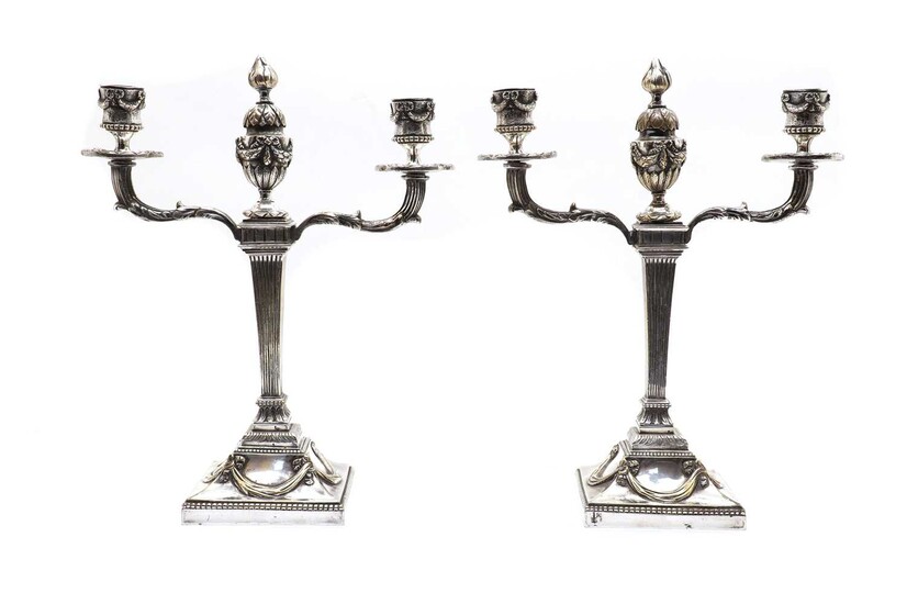 A pair of silvered bronze candelabra