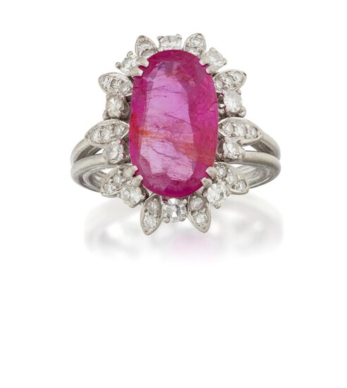 A ruby and diamond cluster ring, the central oval-mixed-cut ruby in four double claw mount, to single-cut diamond three stone stylised leaf border and diamond accents, to a wire work hoop, approximate dimensions of ruby 14.9mm x 8.7mm, approx. ring...