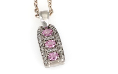 A sapphire and diamond pendant set with three pink sapphires weighing a total of app. 0.71 ct. encircled by numerous brilliant-cut diamonds, mounted in 14k white gold. Accompanied by necklace of sterling silver. Pendant incl. eye-let L. 37 cm. (2)